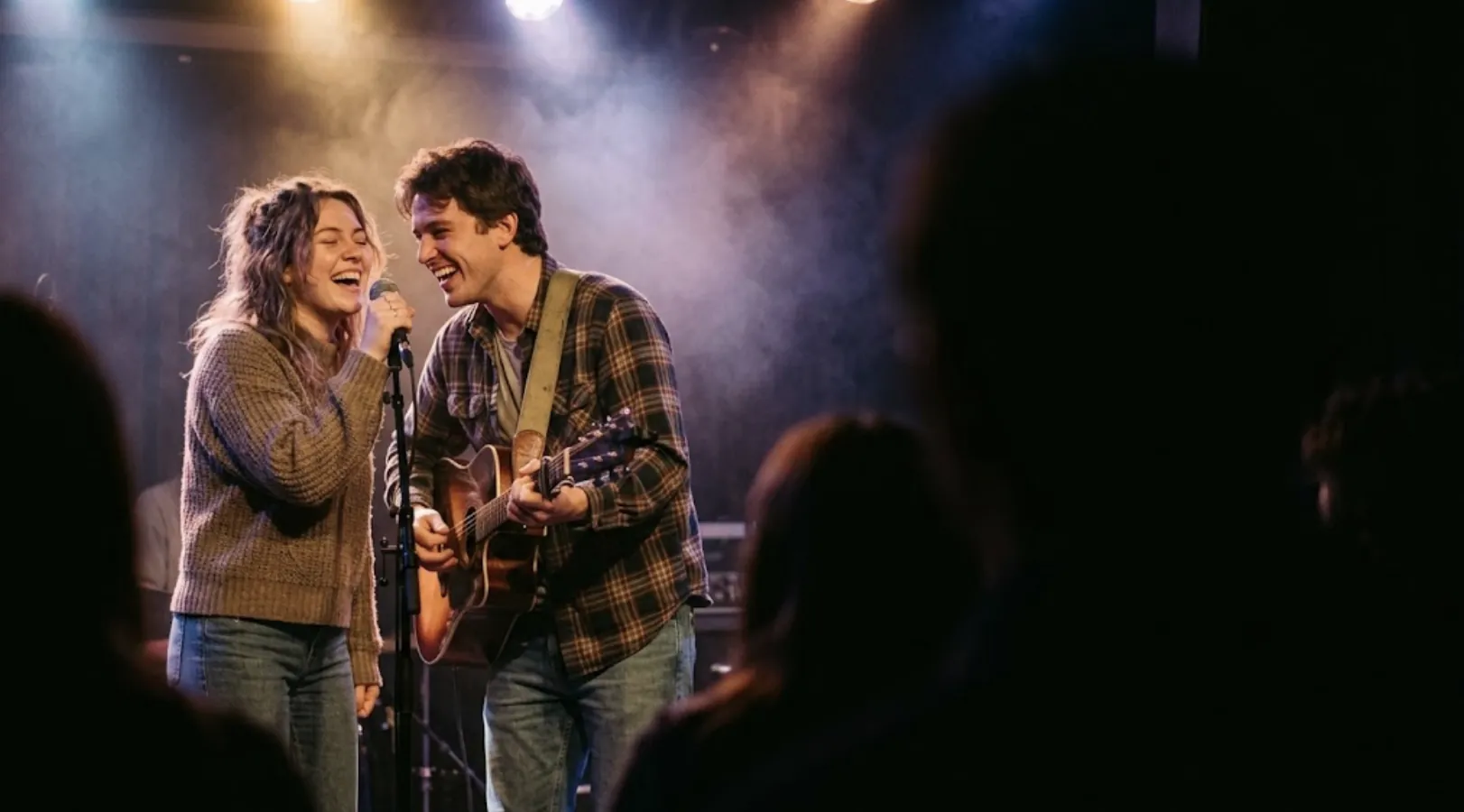 Two musicians singing together on stage